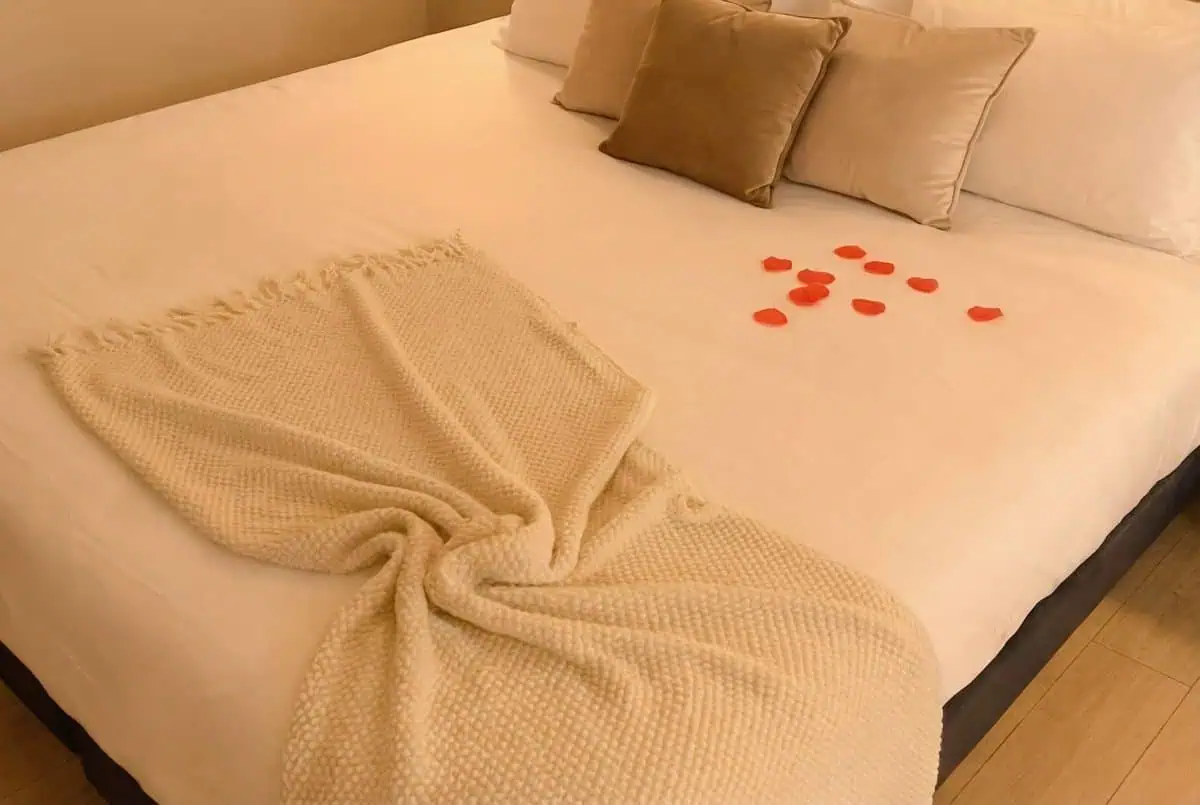 King size bed with rose petals Bulle d'Amour