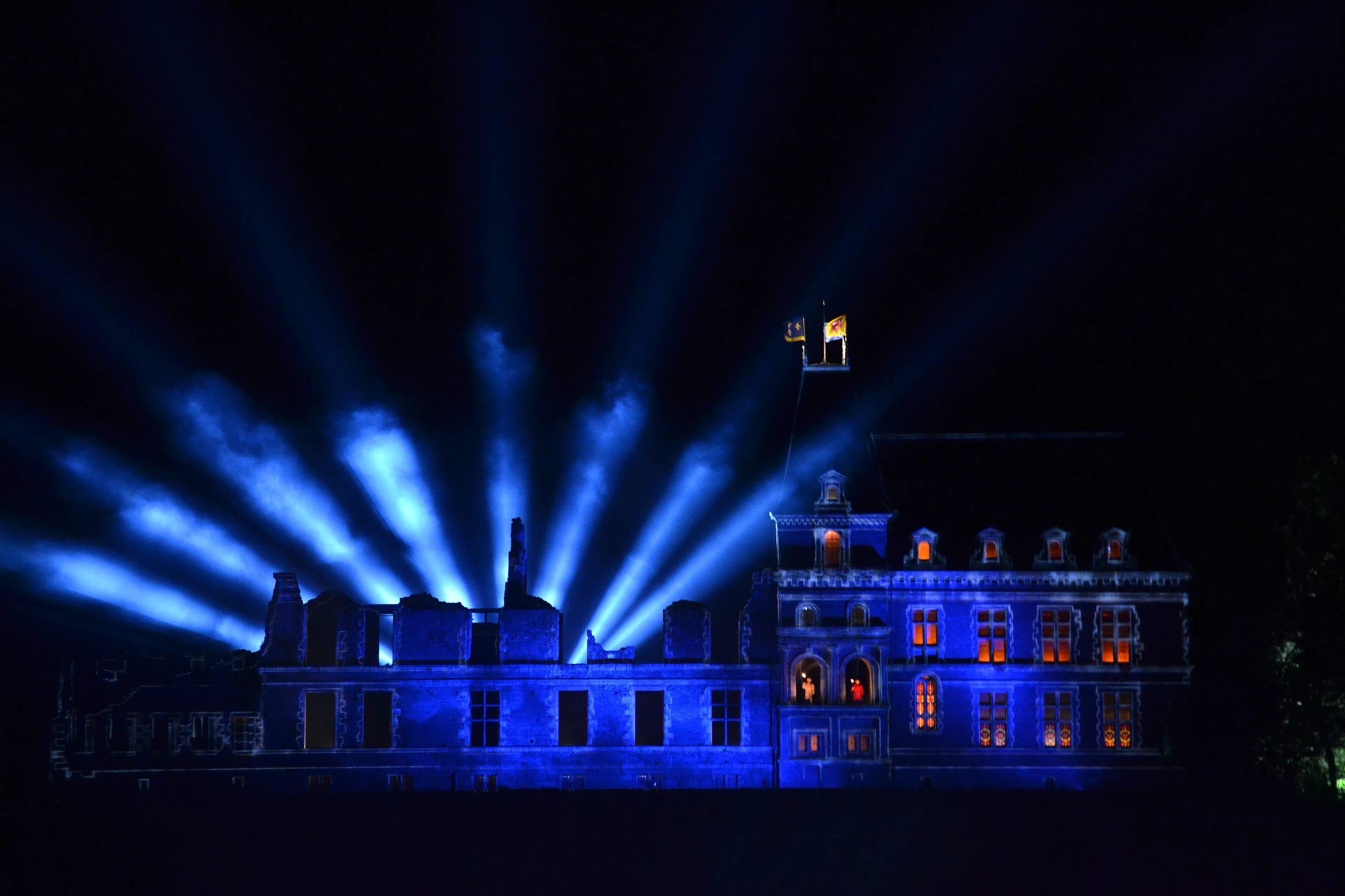 Puy du Fou Castle illuminated for a nighttime show in Vendée